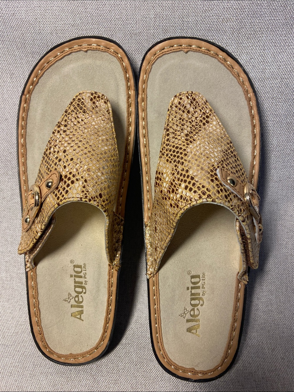 Alegria Women's Vanessa thong sandals in a Leather gold snake print. Size 42
